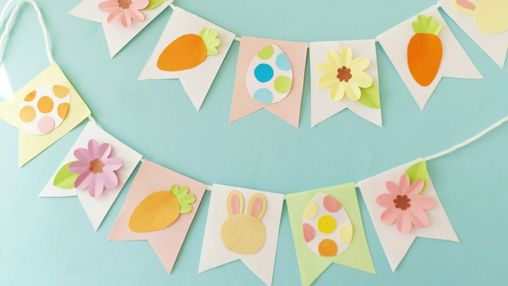 How to Make a Cute Easter Paper Garland (+ Free Template) 1 Handmade Easter paper garland with carrots, eggs, bunnies, and flowers on pastel flags