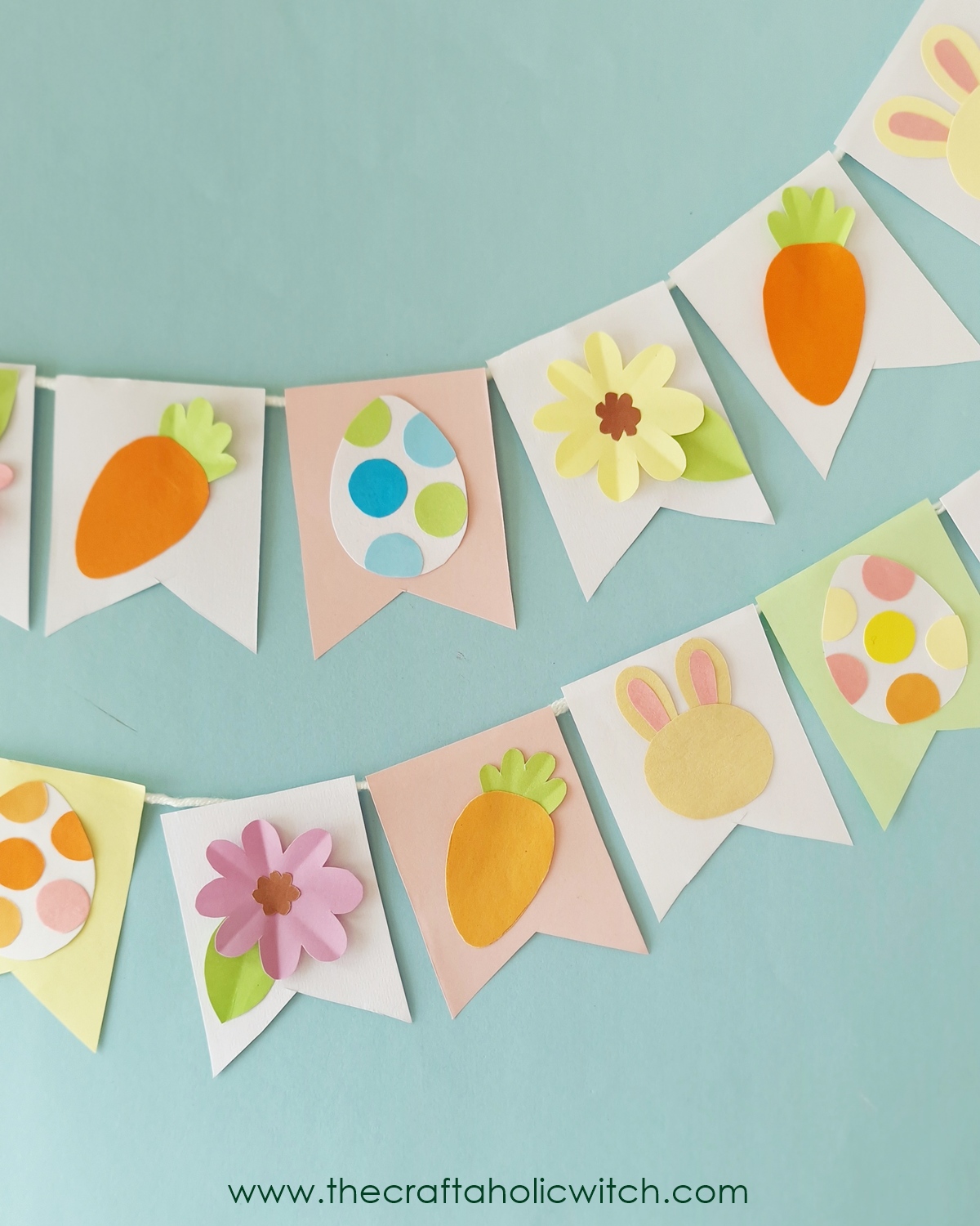 How to Make a Cute Easter Paper Garland (+ Free Template) 2 DIY Easter paper garland hanging on a wall with pastel cut-out shapes and string