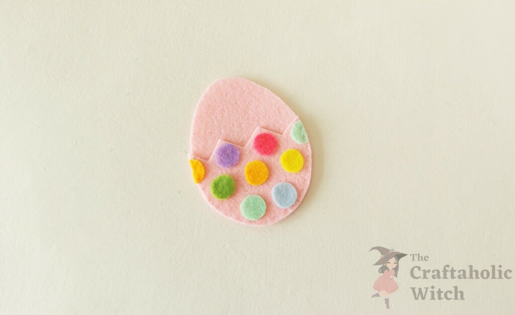 How to Make a Felt Easter Egg Pouch (With Free Template) 9 Fully stitched pink felt Easter egg pouch with colorful dots