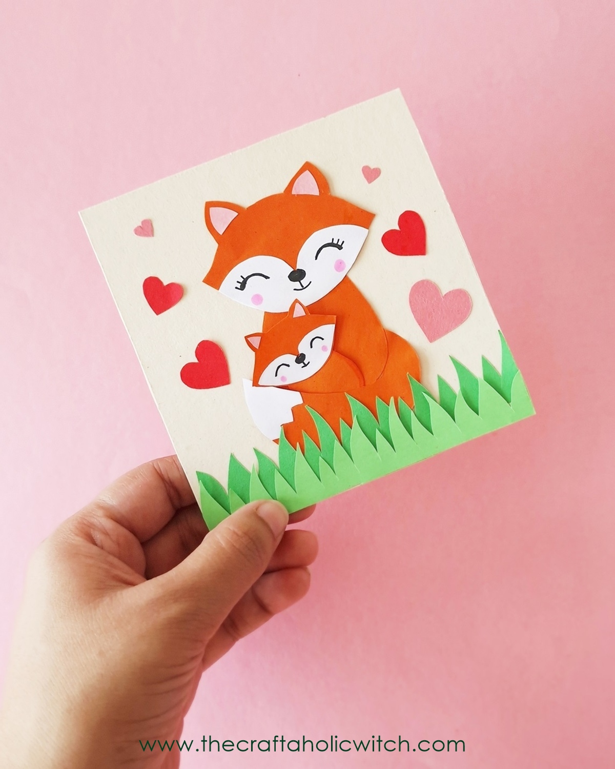 How to Make a Fox Mother’s Day Card (Free Template + Tutorial) 12 DIY Mother’s Day card held by hand, decorated with foxes and paper hearts