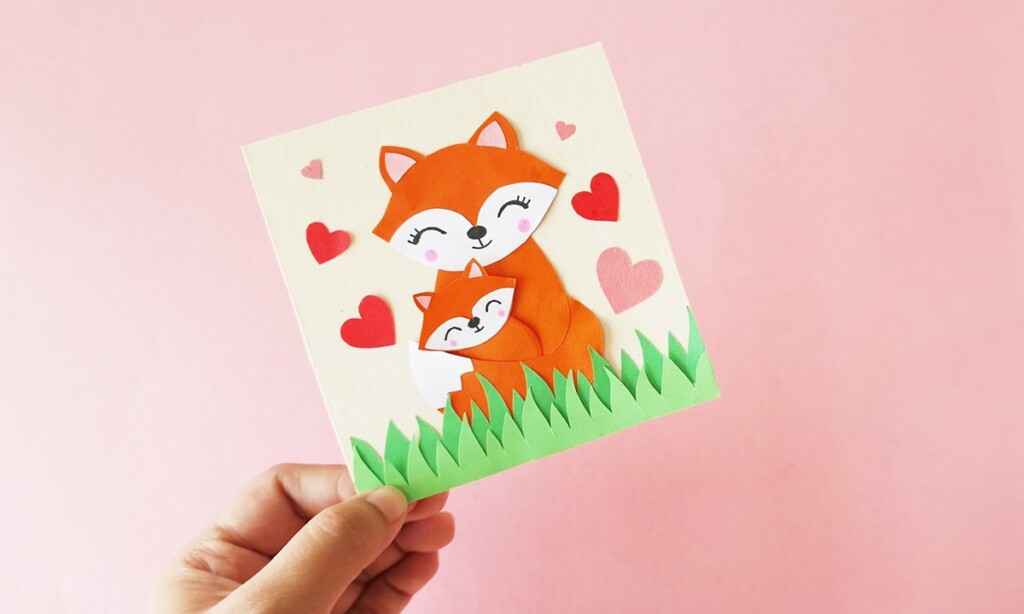 How to Make a Fox Mother’s Day Card (Free Template + Tutorial) 1 Hand holding a handmade fox Mother’s Day card with heart decorations