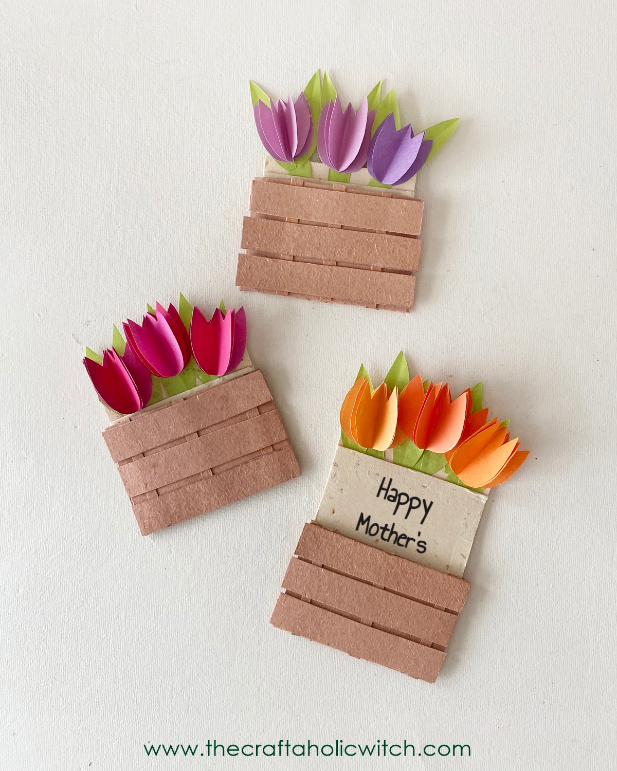 Easy Mother’s Day Card with a Beautiful 3D Tulip Flower Pot (+Free Template) 2 Handmade 3D tulip flower pot Mother's Day cards with colorful paper flowers and a rustic brown pot, made using The Craftaholic Witch's free template.
