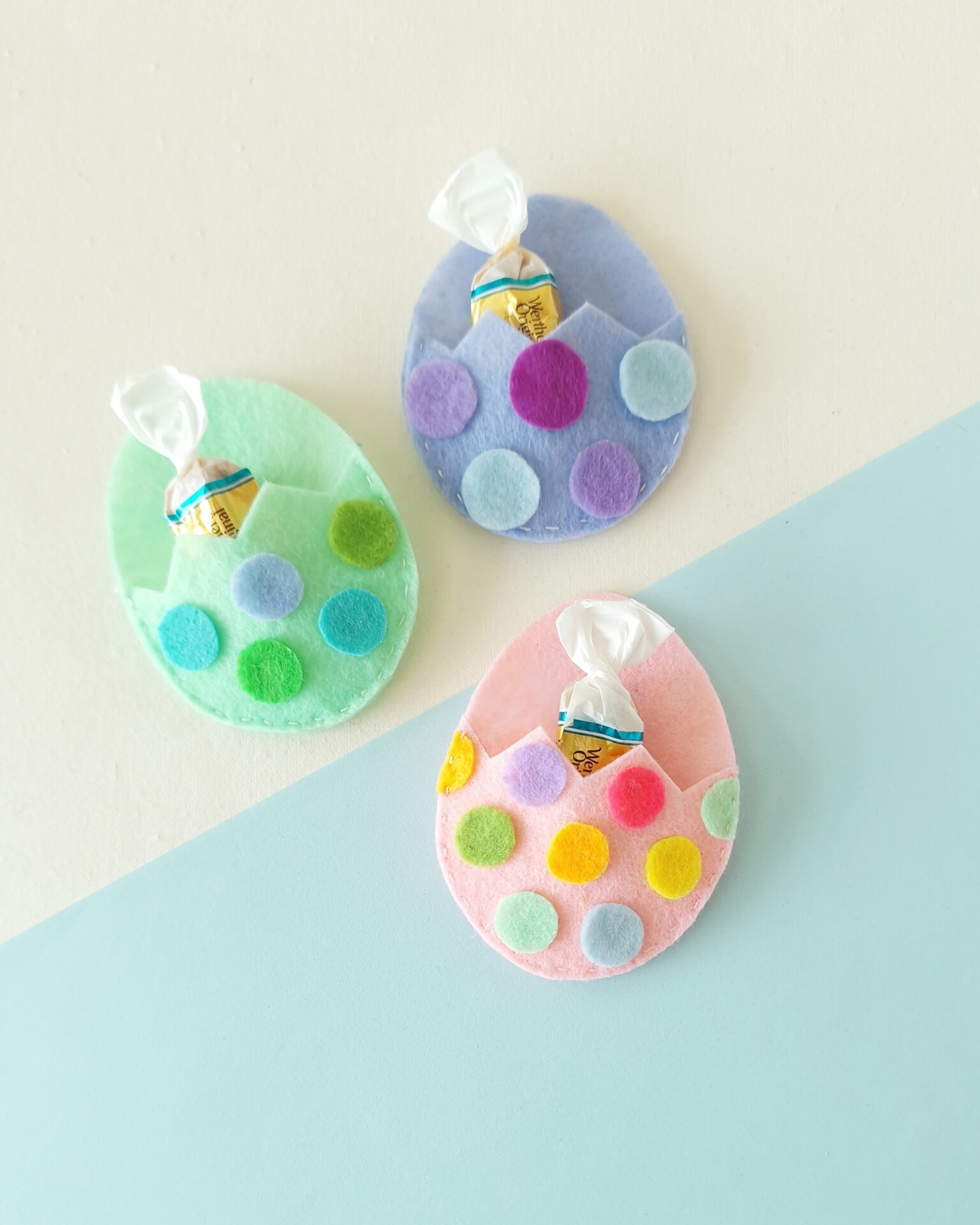 How to Make a Felt Easter Egg Pouch (With Free Template) 2 DIY felt Easter egg pouches with pastel colors and candy inside