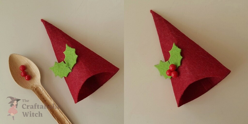 Green felt leaves and red beads glued onto gnome hat as festive Christmas decorations
